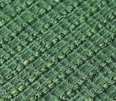 Close-up of a green woven fabric texture with diagonal ribbing and subtle yellowish fibers